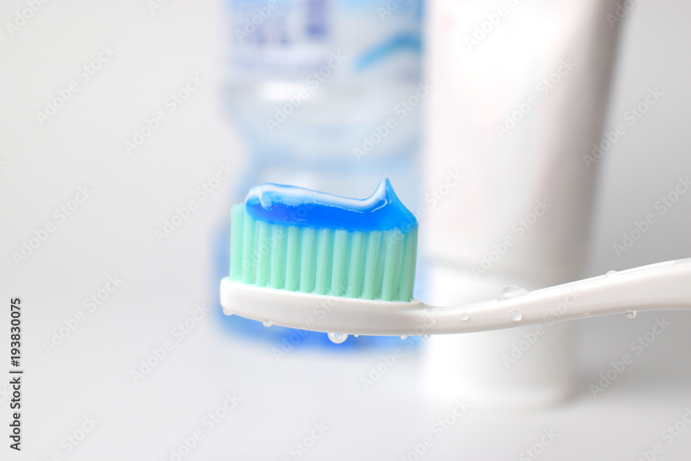 Toothpaste on a toothbrush with water drop Toothpaste on a toothbrush with water drop