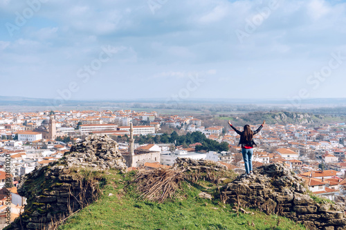 Young girl standing in front of beautiful city view. Panoramic view