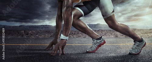 Sports background. Runner feet running on road closeup on shoe. Start line