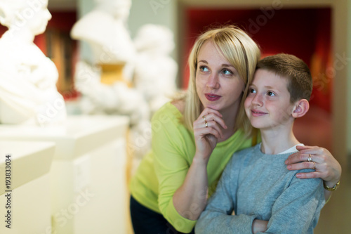Mother and son looking at classical statues