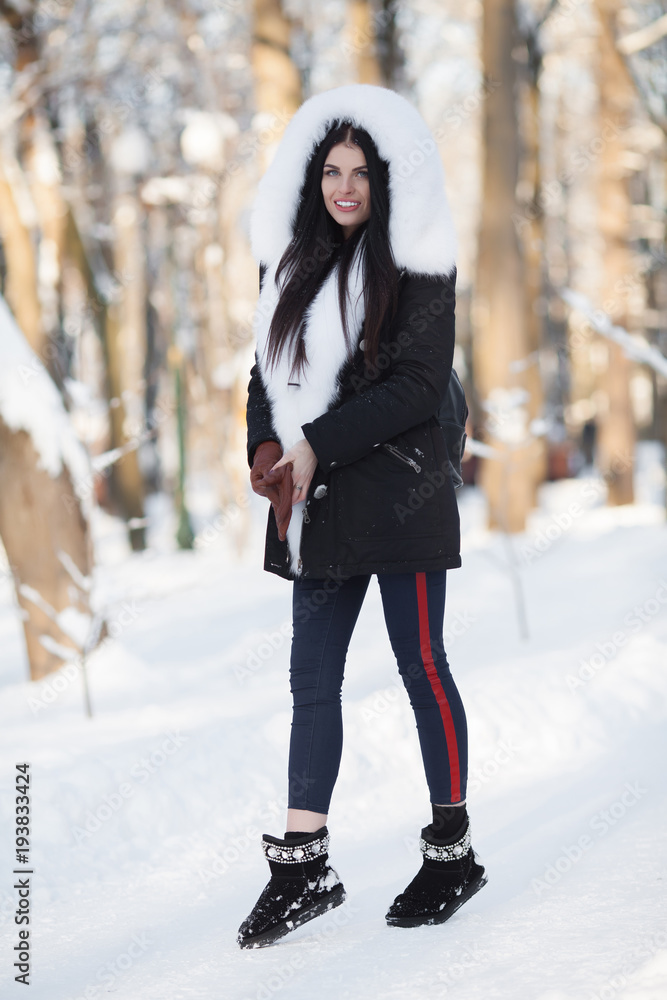 Beautiful winter portrait of young woman in the winter snowy scenery Beautiful winter portrait of young woman in the winter snowy scenery