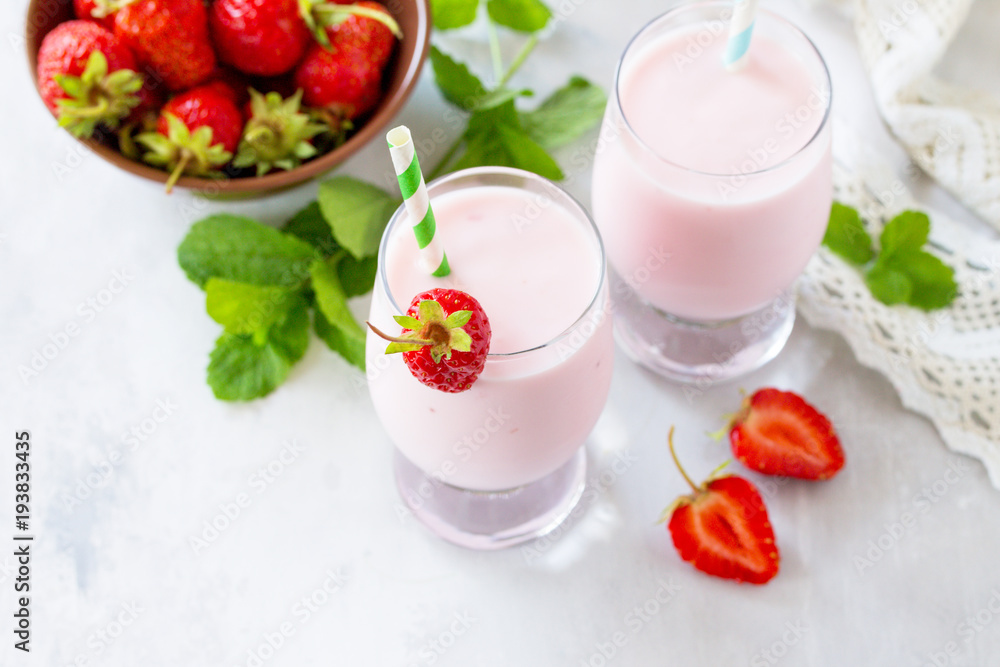 Fresh strawberry smoothie and fresh strawberries on a gray stone or slate background. Vegan dish. Proper nutrition. Healthy lifestyle. Copy space. Fresh strawberry smoothie and fresh strawberries on a gray stone or slate background. Vegan dish. Proper nutrition. Healthy lifestyle. Copy space.