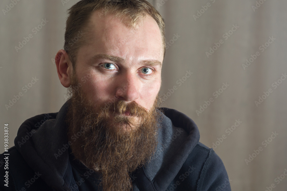 Portrait of a serious man with a long beard Portrait of a serious man with a long beard