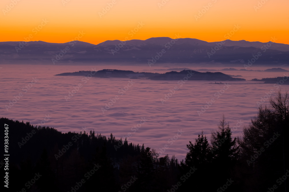 View from mountain Schoeckl over low stratus to Pack, sunset