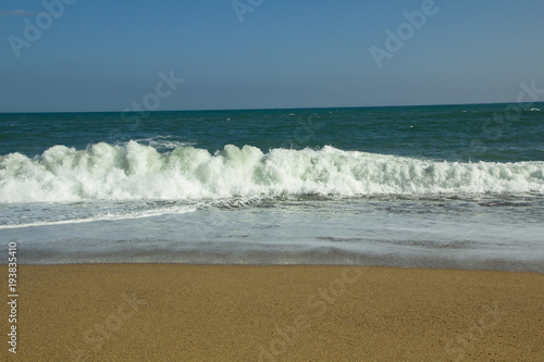Sandstrand am Meer, mit Wellengang, Gischt und rauschendes Wasser