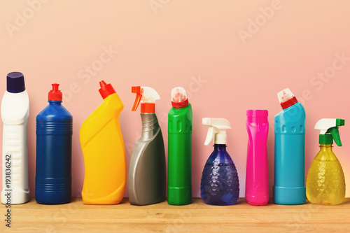 Group of colorful cleaning products on pink background