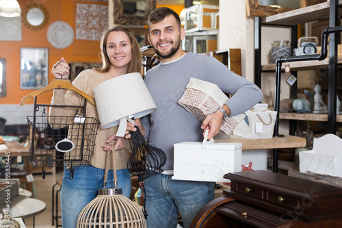 Smiling family demonstrating their buies in shop photo