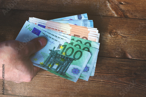 Принти на полотні Hands transferring money on wooden background