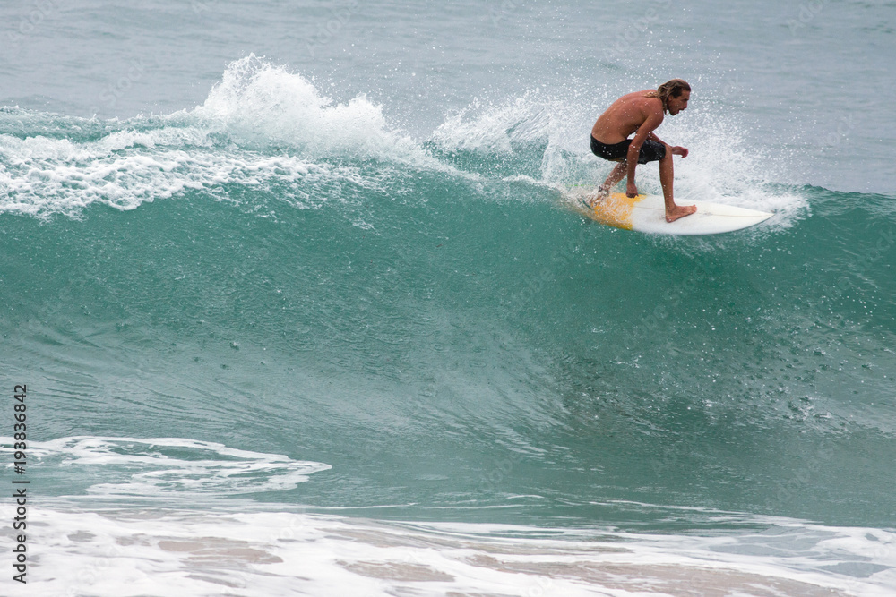 Surfer on Blue Ocean Wave, Bali, Indonesia. Riding in tube. Surfer on Blue Ocean Wave, Bali, Indonesia. Riding in tube.