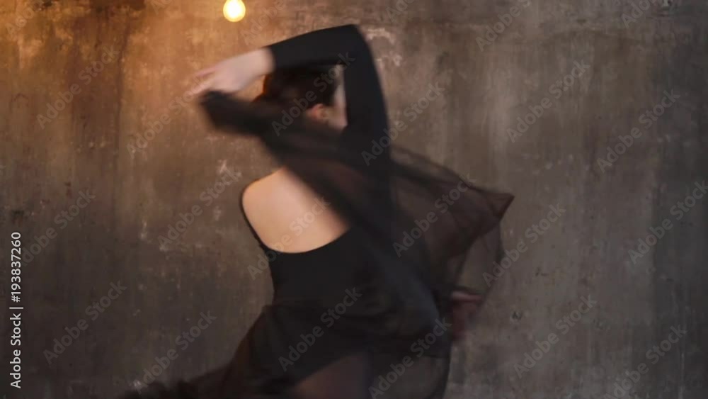 Dancing brunette woman in dancewear and clear dress showing smooth moves. She is spinning pulling her dress up. Dancing brunette woman in dancewear and clear dress showing smooth moves. She is spinning pulling her dress up.