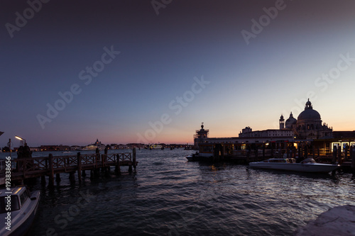 VENICE, ITALY - FEBRUARY 10 2018: vaporetto terminal at sunset in front of Basilica della Salute. The vaporetto is the public means par excellence of the city