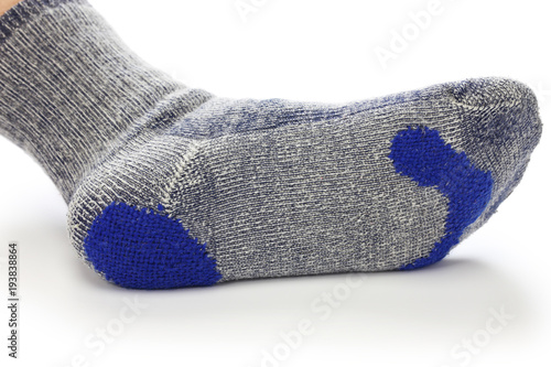 darning socks, repairing holes in socks on white background photo