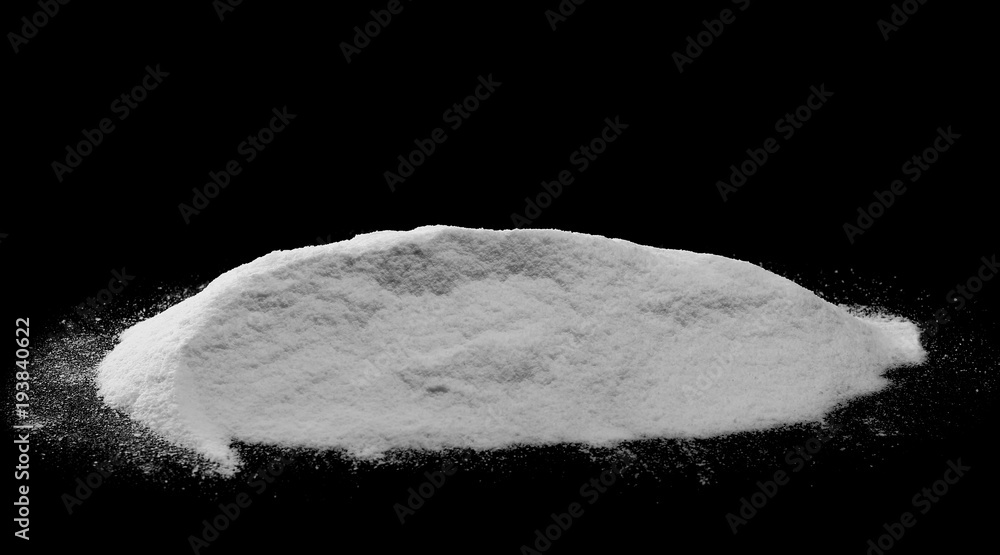 Pile of coconut flour, powder isolated on black background