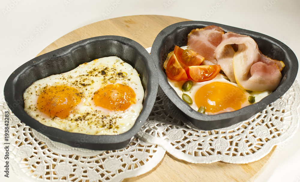 Eggs and bacon in a heart-shaped pan. Eggs and bacon in a heart-shaped pan.