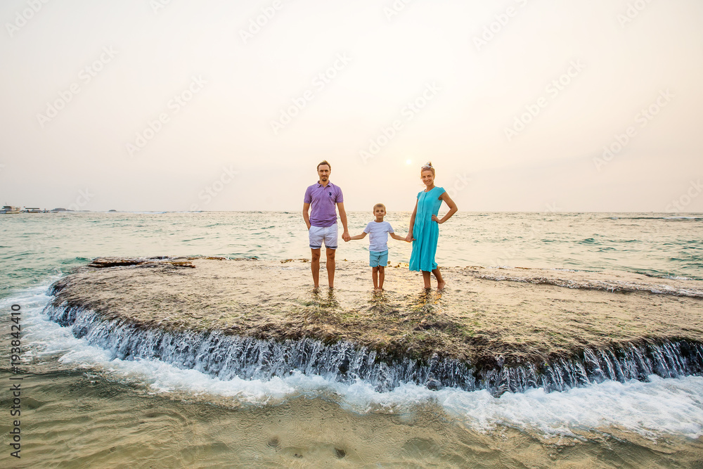 Family on vacation at the seashore of Indian ocean