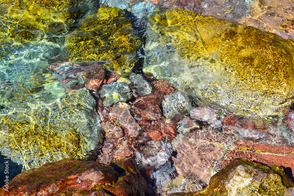 Sea. Large coastal colorful stones in the water at the shore. Clear water. Adriatic Sea