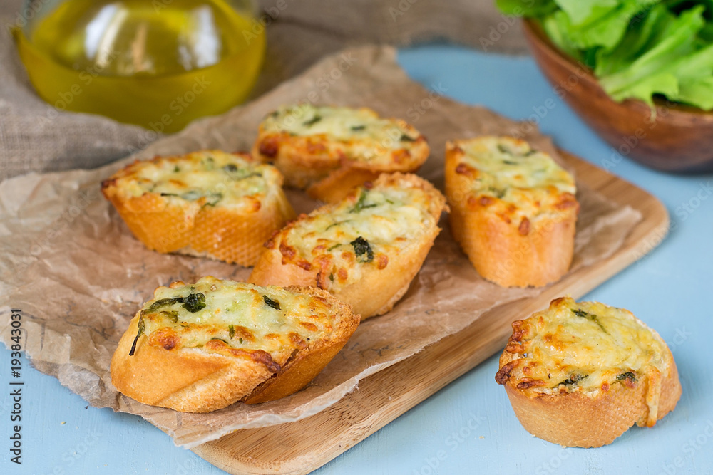Homemade garlic bread with grated cheese and parsley Homemade garlic bread with grated cheese and parsley