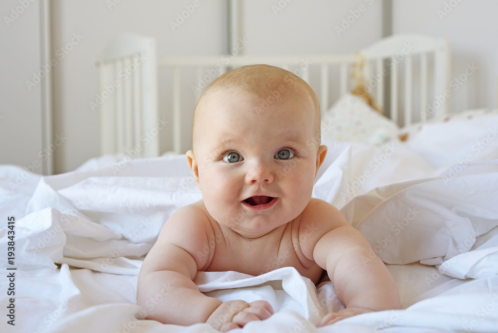 Baby smiling in a bed