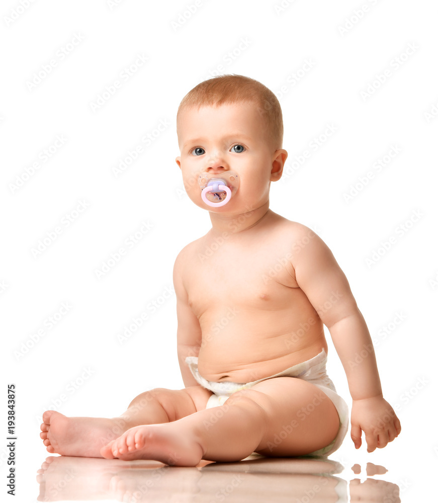 Infant child boy toddler in diaper sitting with nipple baby pacifier happy Infant child boy toddler in diaper sitting with nipple baby pacifier happy