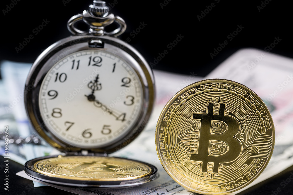Golden bitcoin and pocket watch near on us dollars with black background