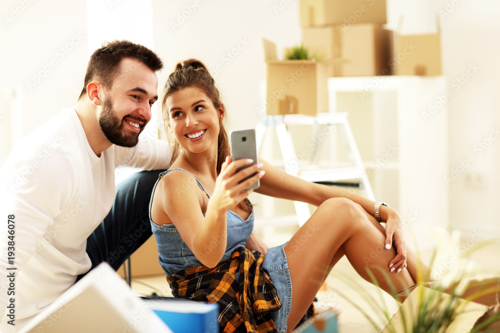 Happy adult couple moving out or in to new home Happy adult couple moving out or in to new home
