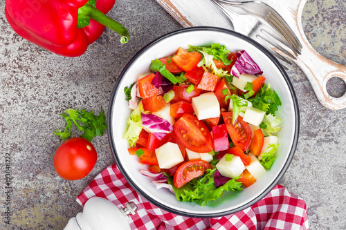 Vegetable dish, salad with bell pepper, tomato, italian mix, fresh lettuce and mozzarella cheese. Healthy food. Top view