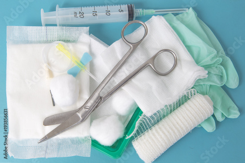 opened sterile dressing pack lying at the table ready to treat the wound