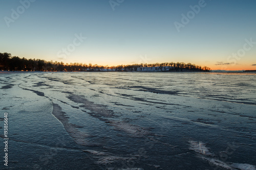 Ice-lined lake at sunset