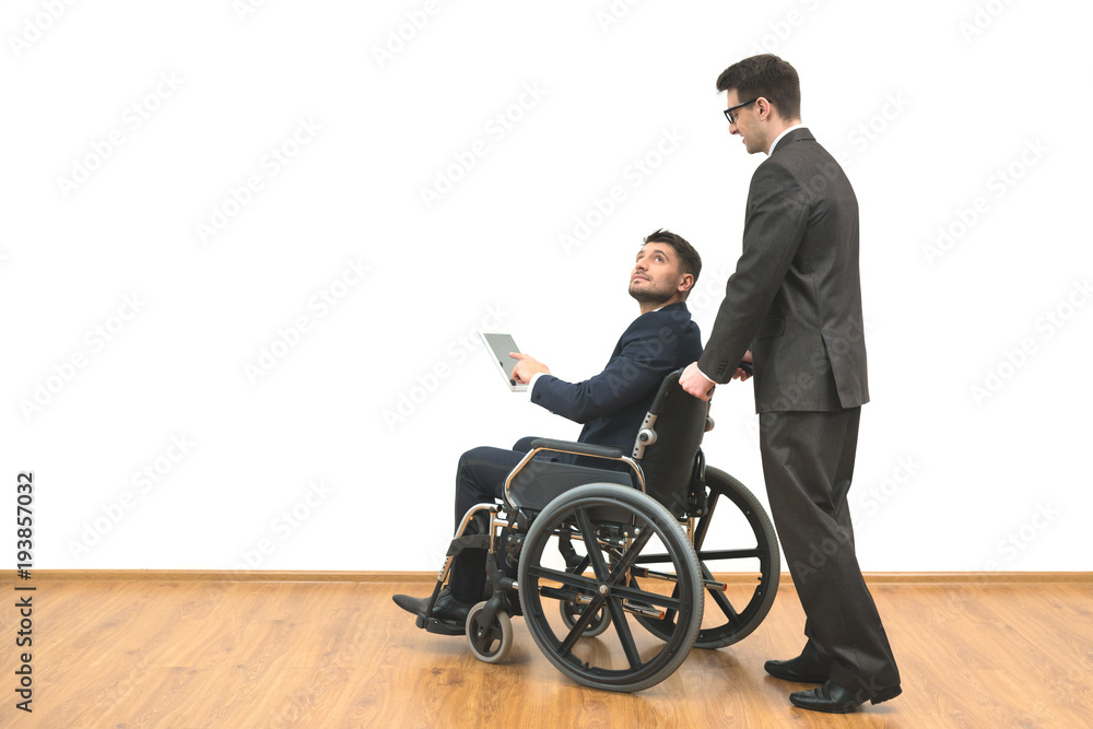 The man carrying a wheelchair with a disabled on the white wall background The man carrying a wheelchair with a disabled on the white wall background