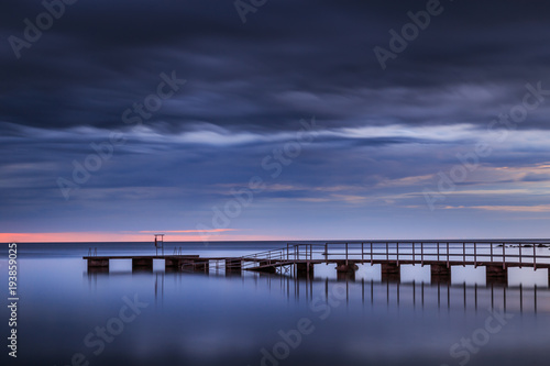 long pier leading into the ocean at sunset © Kilman Foto