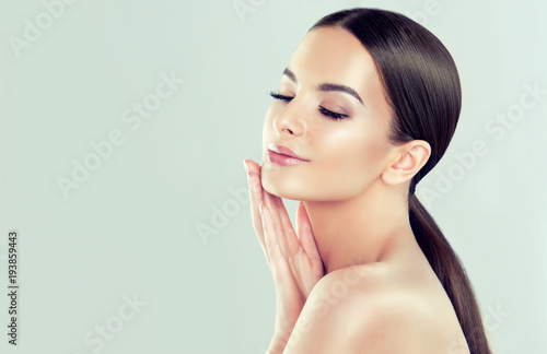 Beautiful young woman with clean fresh skin  .Girl  beauty face care. Facial  treatment   .
