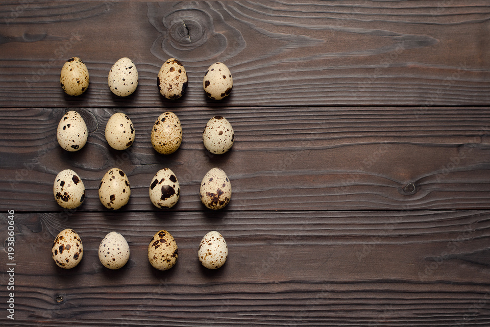 Quail eggs on dark wooden background. The view from the top. Copy spaсe Quail eggs on dark wooden background. The view from the top. Copy spaсe