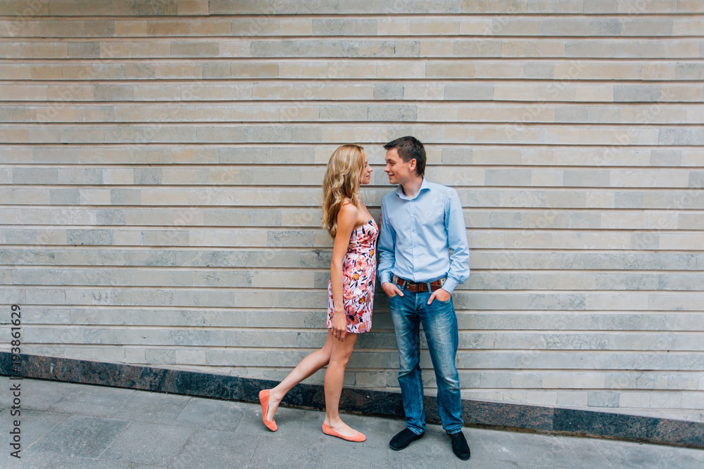 Young happy couple hugging on the street. Smiling man and woman having fun in the city. Young happy couple hugging on the street. Smiling man and woman having fun in the city.