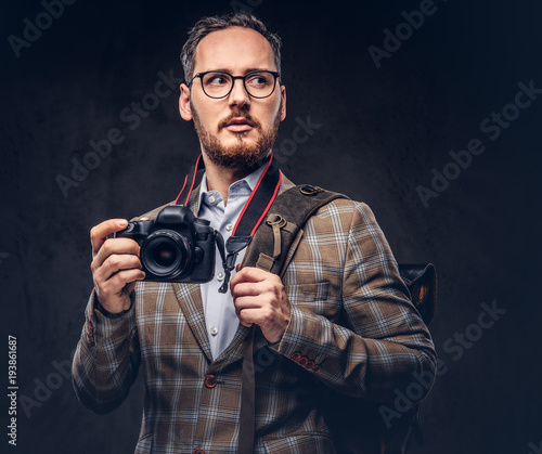 Traveler and photographer. Studio portrait of a handsome bearded
