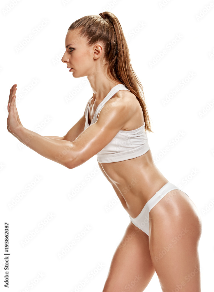 Fit strong sporty girl. Fit strong sporty woman in white drawers training Fit strong sporty girl. Fit strong sporty woman in white drawers training