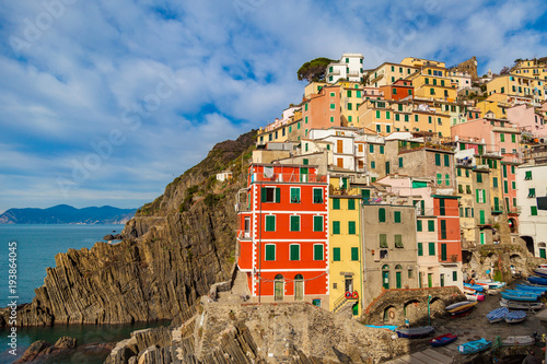 Scenic view of Riomaggiore with its colorful buildings and coastline. Cinque Terre, Liguria, Italy