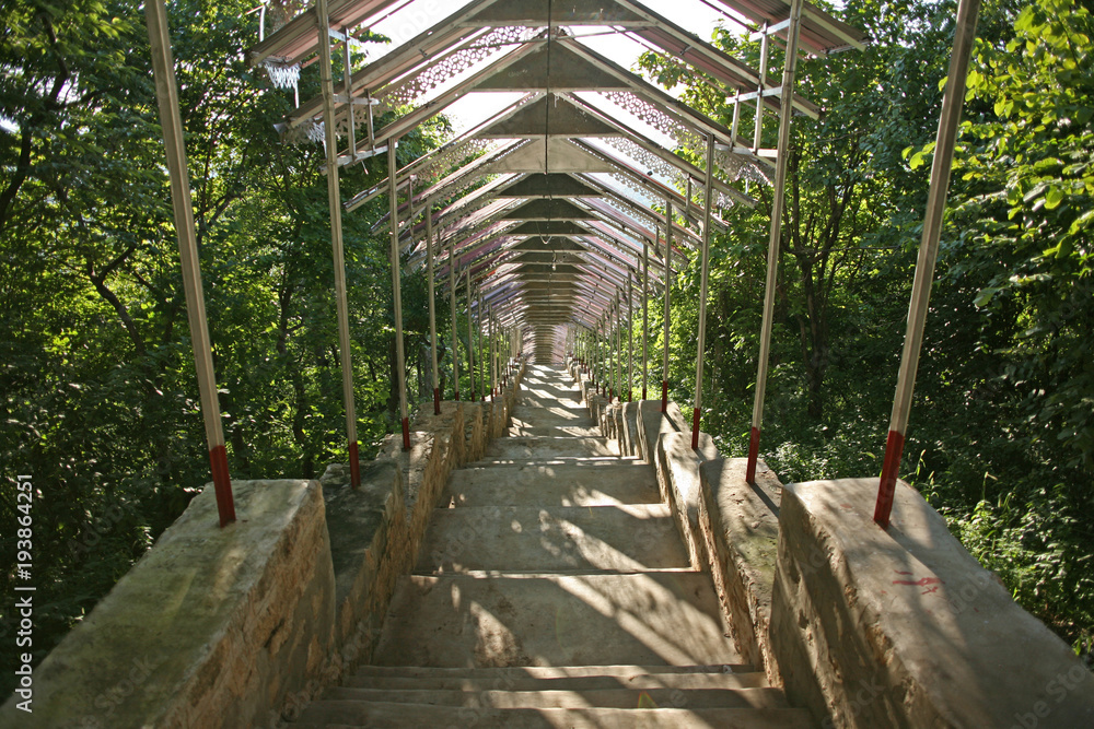 The extensive steps leading to the pagoda complex at the summit of the hill of the Su Taung Pyae Pagoda above Mandalay in Myanmar The extensive steps leading to the pagoda complex at the summit of the hill of the Su Taung Pyae Pagoda above Mandalay in Myanmar