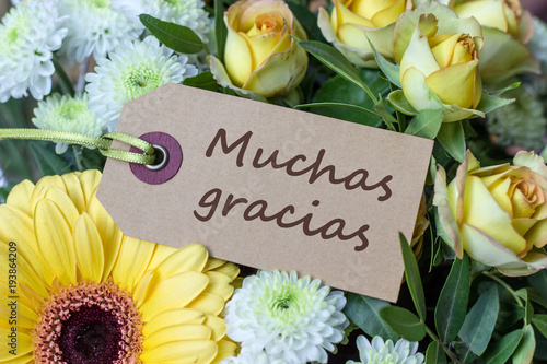 Thank you /Bouquet of yellow and white roses, gerberas, chrysanthemums and greeting card with spanish text: Thank you 