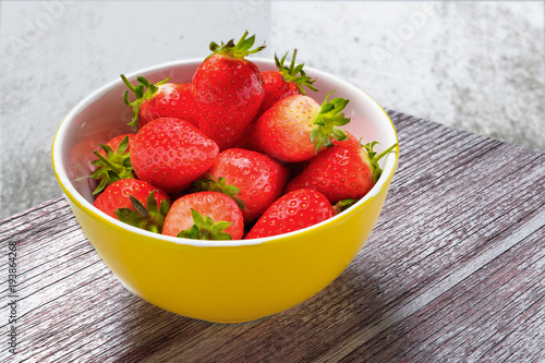 Fresh strawberry in the yellow bowl, sweet spring strawberries closeup