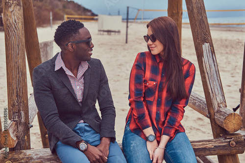 Attractive couple on the beach. African-American guy and Caucasi photo