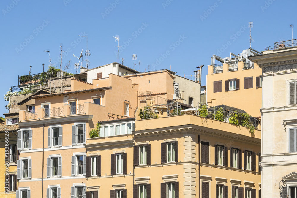 Yellow, orange and brown houses as seen in sunny day in Rome, Italy. June, daytime.