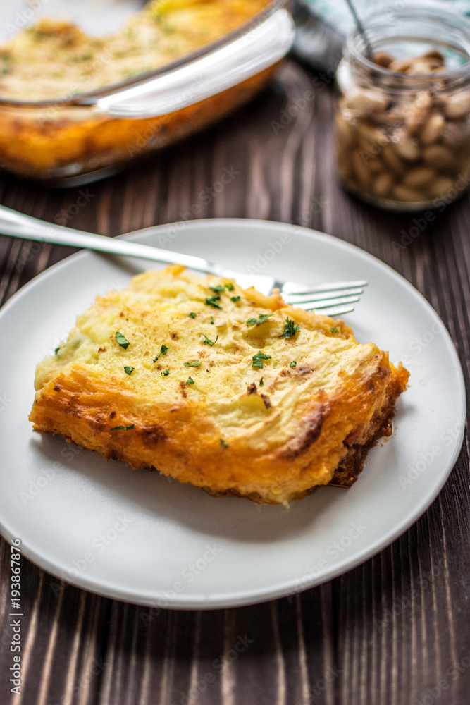 Shepherd's pie on a wooden background Shepherd's pie on a wooden background