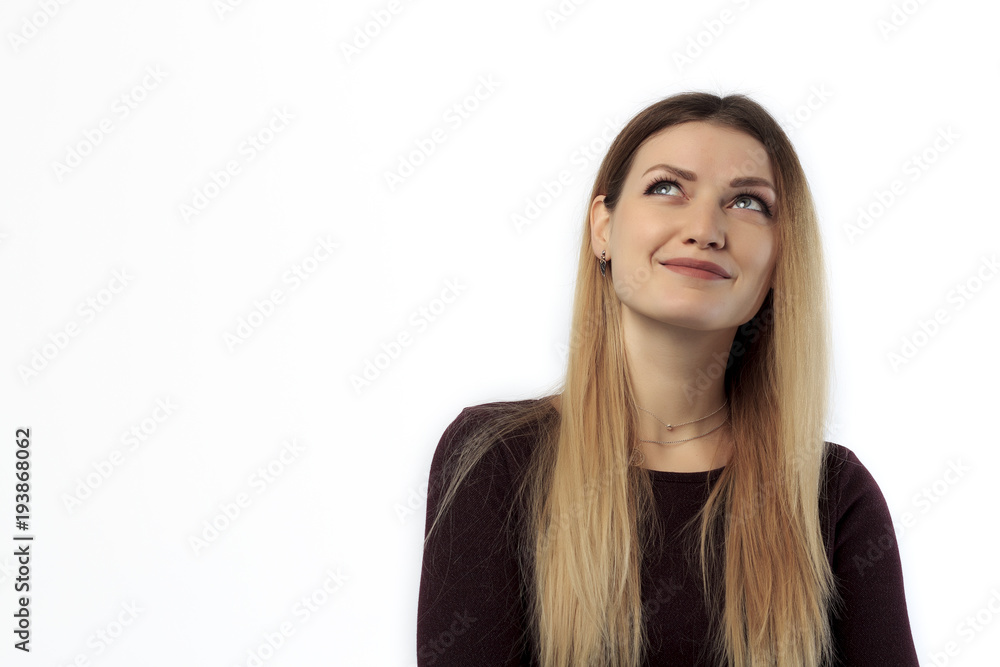 Close-up portrait of a casual pretty young smiling girl thinking about something isolated on the white background Close-up portrait of a casual pretty young smiling girl thinking about something isolated on the white background