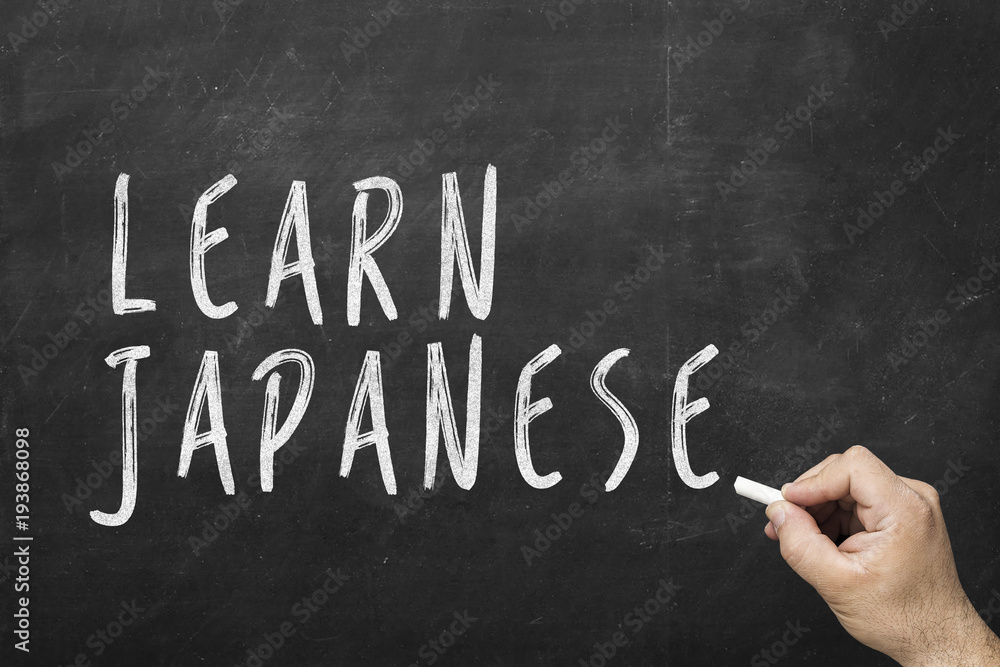 Fototapeta premium Human hand writing text on blackboard: Learn japanese