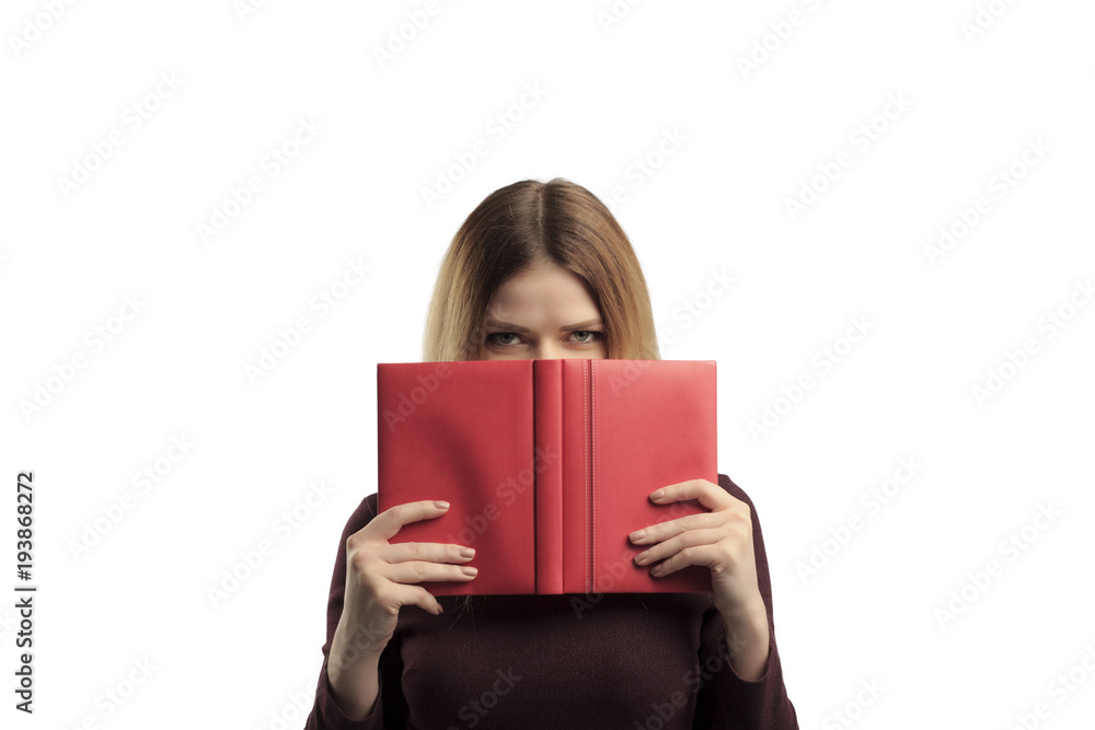 Portrait of a pretty casual girl holding open book at her face isolated over white background Portrait of a pretty casual girl holding open book at her face isolated over white background