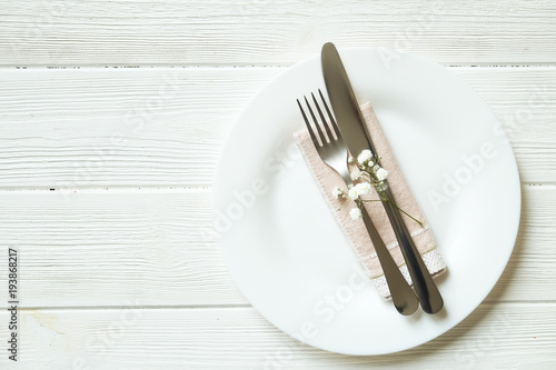 Easter laying table appointments  table setting options. Silverware  tableware items with festive decoration. Fork  knife and flowers. Happy easter holiday.