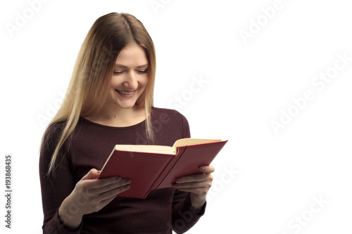 Young female happily reading book, isolated on white