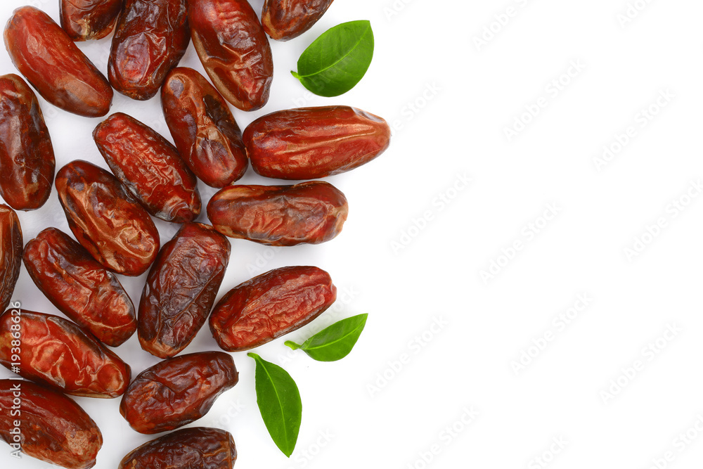 dry dates with green leaves isolated on white background with copy space for your text. Top view. Flat lay pattern dry dates with green leaves isolated on white background with copy space for your text. Top view. Flat lay pattern