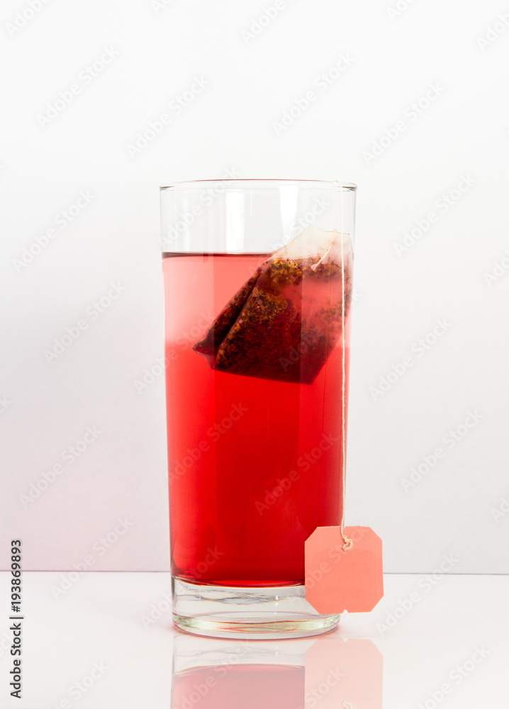 red fruit tea glas with bag isolated with white background and reflection red fruit tea glas with bag isolated with white background and reflection