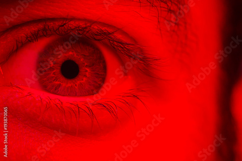 Macro on man eye expressing shocked surprise and fear expression